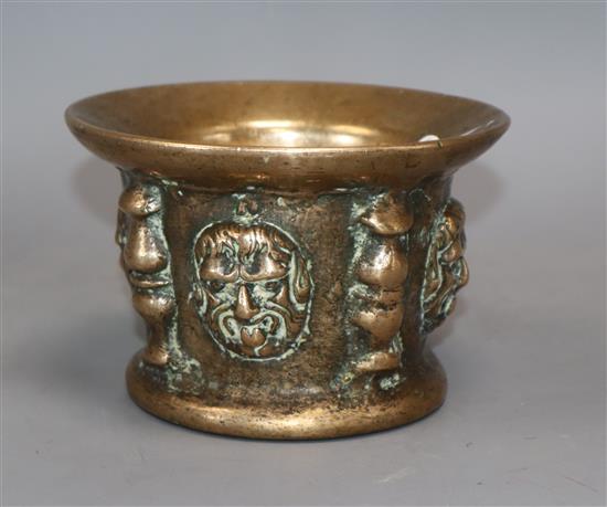 A Spanish bronze mortar cast with masks and buttresses (probably 16th or 17th century) diameter 14.5cm